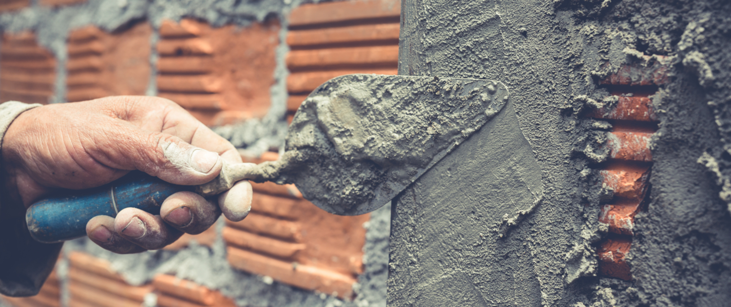 Bricklaying. Construction worker building a brick wall.
